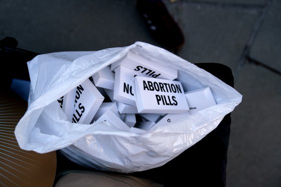 Abortion pills are passed out at a protest opposing the U.S. Supreme Court overturning of Roe v. Wade.