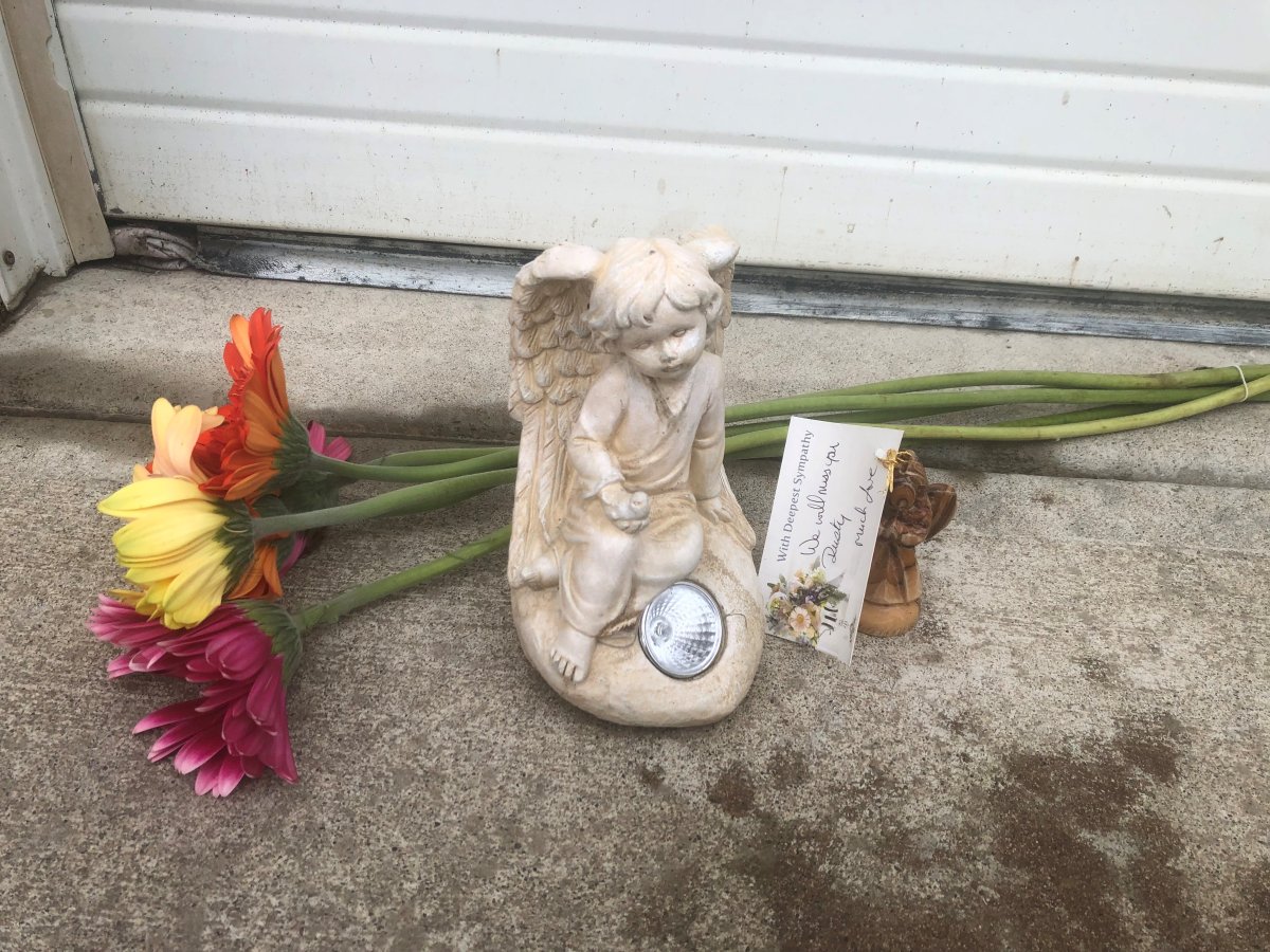 A memorial sits outside the garage of Betty Williams who lost her life to a dog attack.
