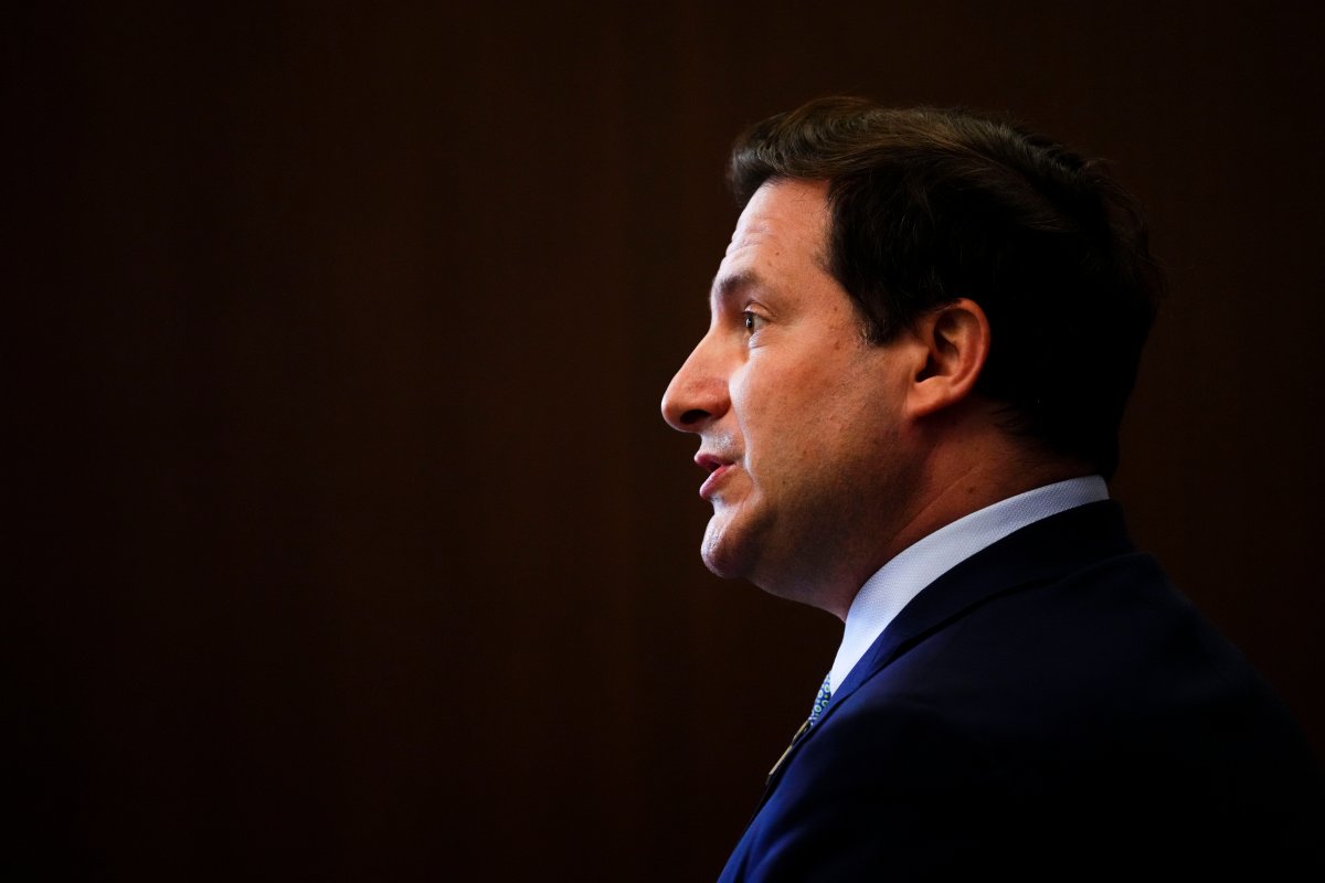 Public Safety Minister Marco Mendicino is in side profile against a black backdrop.