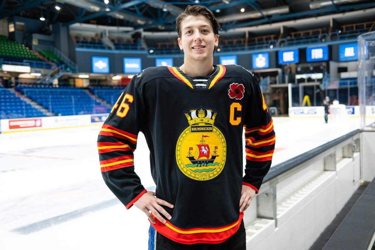 Saint John captain Vincent Sevigny shows off the commemorative uniform that the Sea Dogs will wear in the opening game of the 2022 Memorial Cup tournament.
