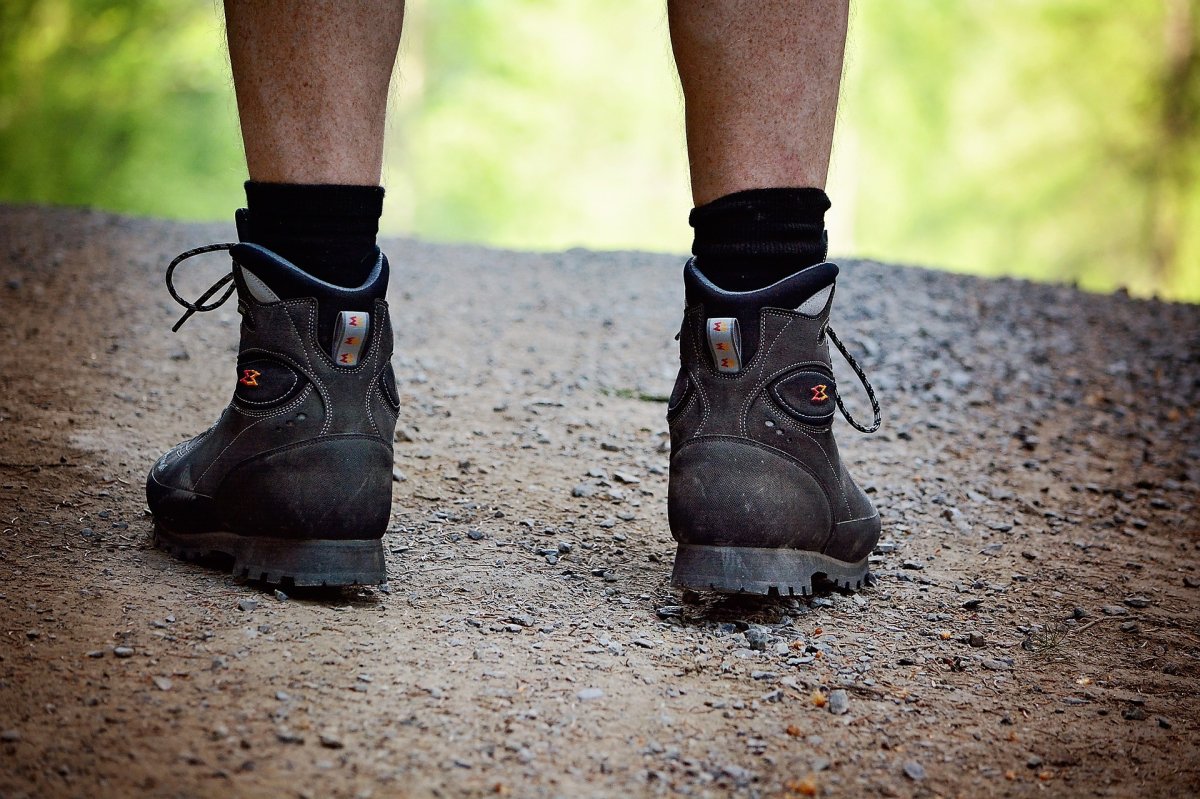 A file photo of a man wearing hiking boots out for a walk on a trail.