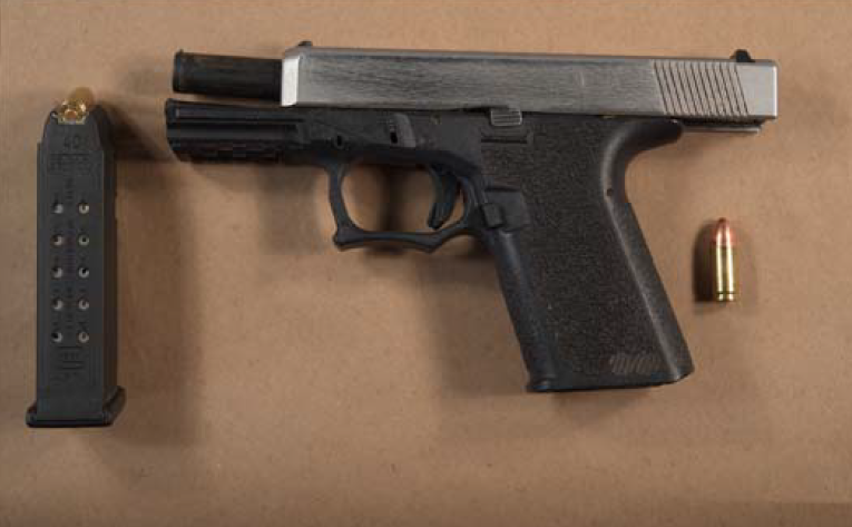 A loaded firearm that was in possession of one of the suspects, was seized by police after an officer received death threats in a parking lot on June 13, 2022.