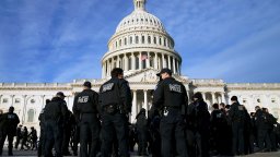 The U.S. Capitol building is seen with police gathered in front.