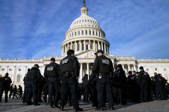 The U.S. Capitol building is seen with police gathered in front.