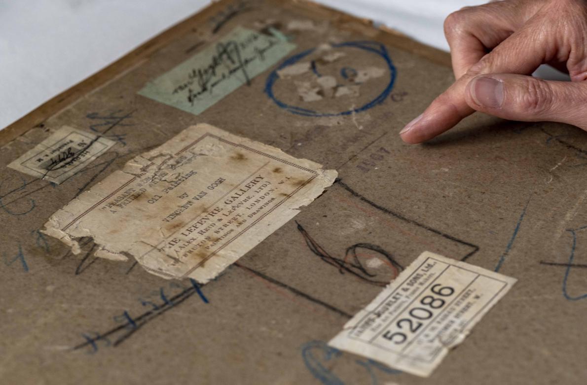 The back of "Head of a Peasant Woman." The canvas is covered in layers of glue and cardboard. Underneath is the self-portrait of Vincent Van Gogh. The condition is unknown.