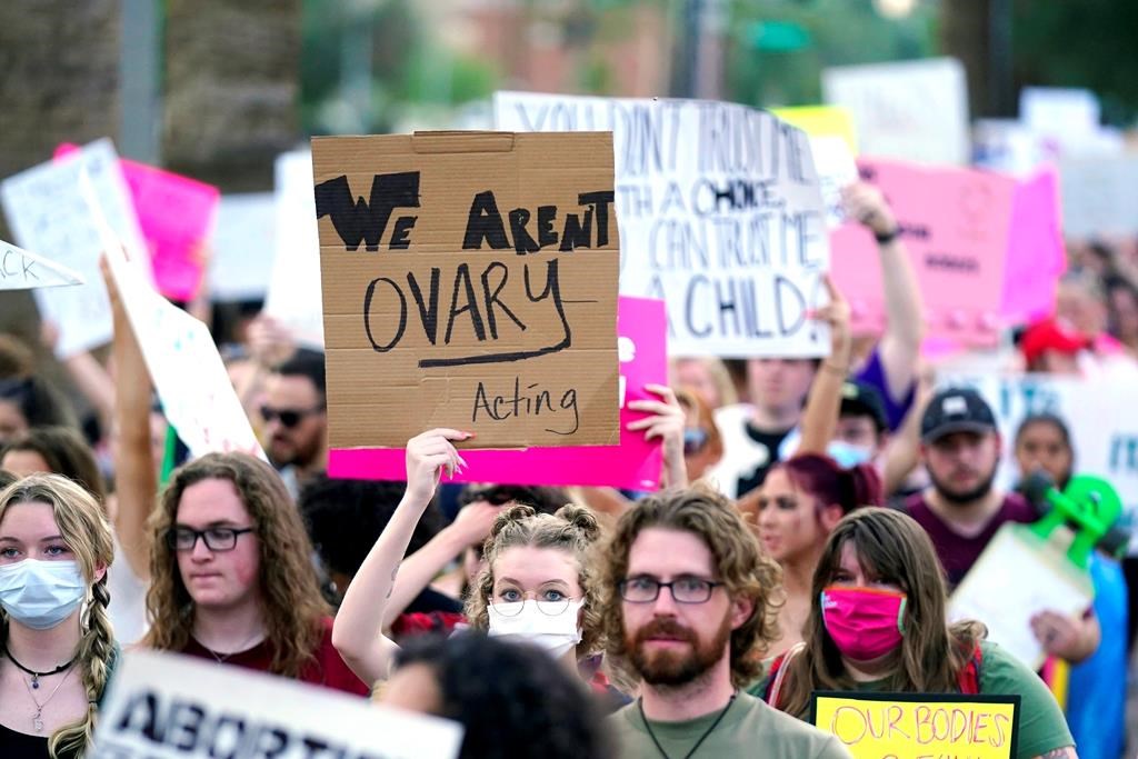 Thousands of protesters march around the Arizona Capitol after the Supreme Court decision to overturn the landmark Roe v. Wade abortion decision Friday, June 24, 2022, in Phoenix. The Supreme Court on Friday stripped away women’s constitutional protections for abortion, a fundamental and deeply personal change for Americans' lives after nearly a half-century under Roe v. Wade. The court’s overturning of the landmark court ruling is likely to lead to abortion bans in roughly half the states. (AP Photo/Ross D. Franklin).