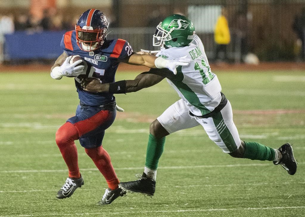 Saskatchewan Roughriders' Larry Dean (11) attempts a tackle on Montreal Alouettes' Walter Fletcher during second half CFL football action in Montreal, Thursday, June, 23, 2022. THE CANADIAN PRESS/Graham Hughes.