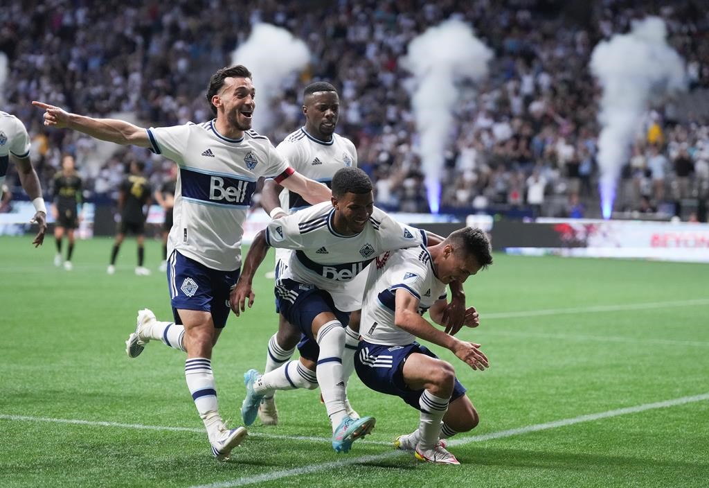 Vancouver Whitecaps' Russell Teibert, front left to right, Pedro Vite, Andres Cubas and Cristian Dajome, back, celebrate Cubas' goal against Los Angeles FC during the second half of an MLS soccer game in Vancouver, on Saturday, July 2, 2022.