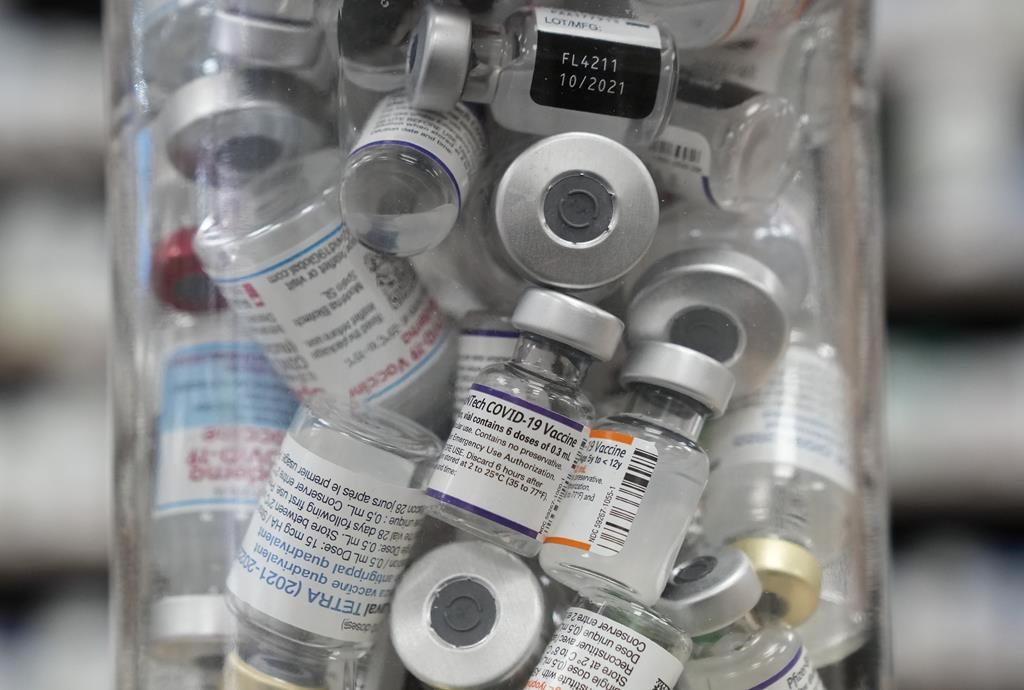 A jar full of empty COVID-19 vaccine vials is shown at the Junction Chemist pharmacy during the COVID-19 pandemic in Toronto on Wednesday, April 6, 2022. THE CANADIAN PRESS/Nathan Denette.