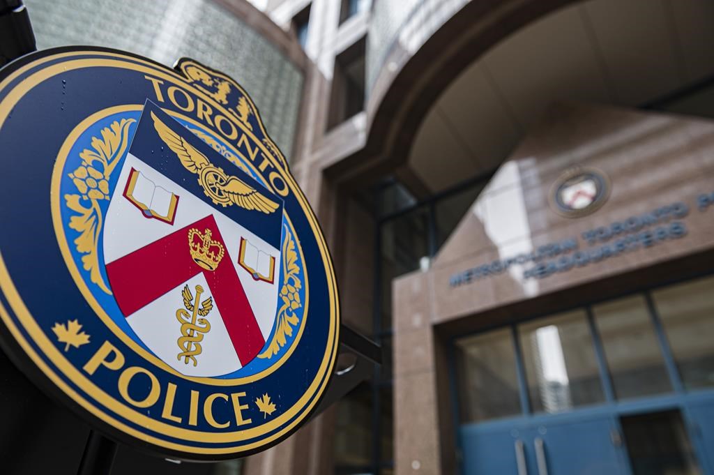 The Toronto Police Services emblem is photographed during a press conference at TPS headquarters, in Toronto on Tuesday, May 17, 2022. Toronto police are offering two rewards of up to $50,000 each in an effort to arrest two men wanted in separate murder investigations. THE CANADIAN PRESS/Christopher Katsarov.