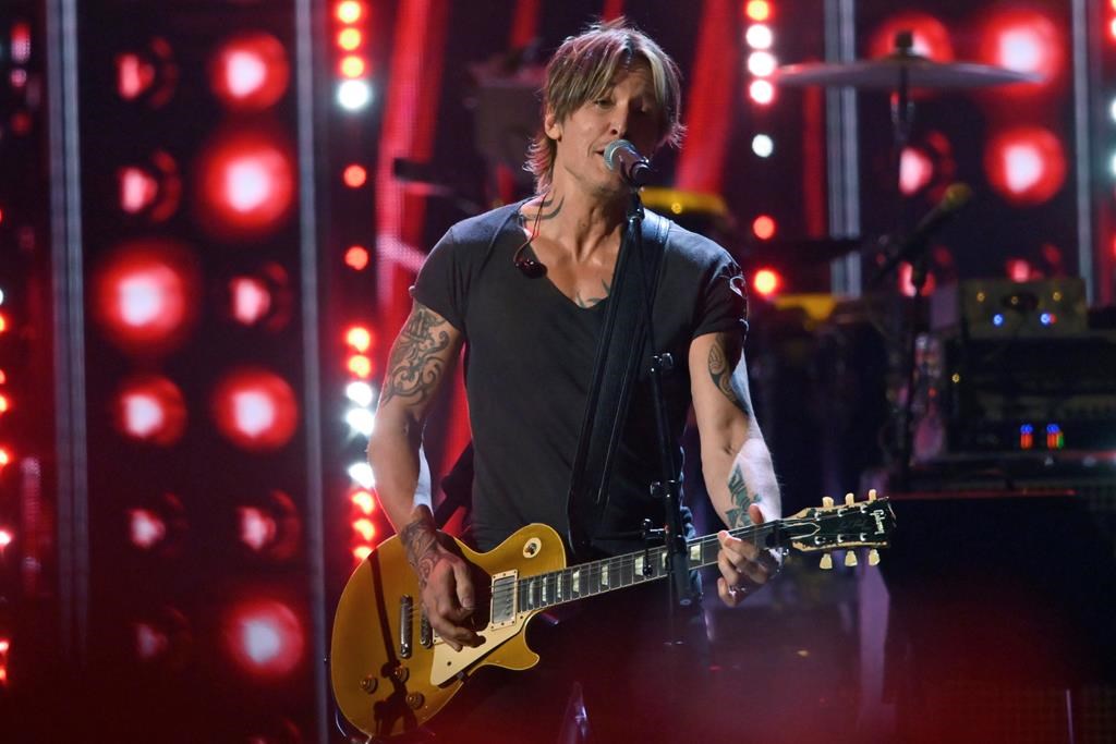 Keith Urban performs during the Rock and Roll Hall of Fame Induction ceremony, Saturday, Oct. 30, 2021, in Cleveland. Canadian concertgoers are being asked to save or print off their tickets as a widespread network outage at Rogers Communications Inc. stymied mobile internet access for many.