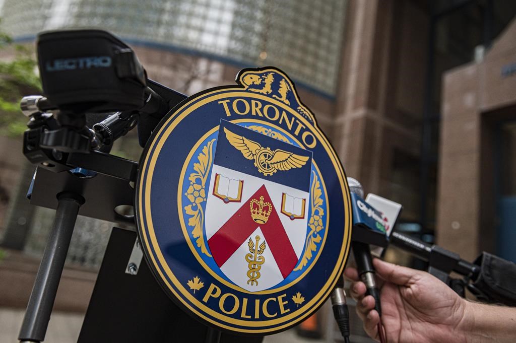 The Toronto Police Services emblem is photographed during a press conference at TPS headquarters, in Toronto on Tuesday, May 17, 2022. Charges against a Toronto man that were laid after a woman was set on fire on a transit bus last month have been upgraded following the woman's death. THE CANADIAN PRESS/Christopher Katsarov.