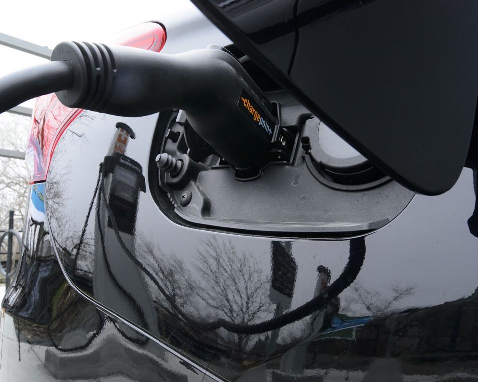 Charging unit being plugged into electric vehicle.