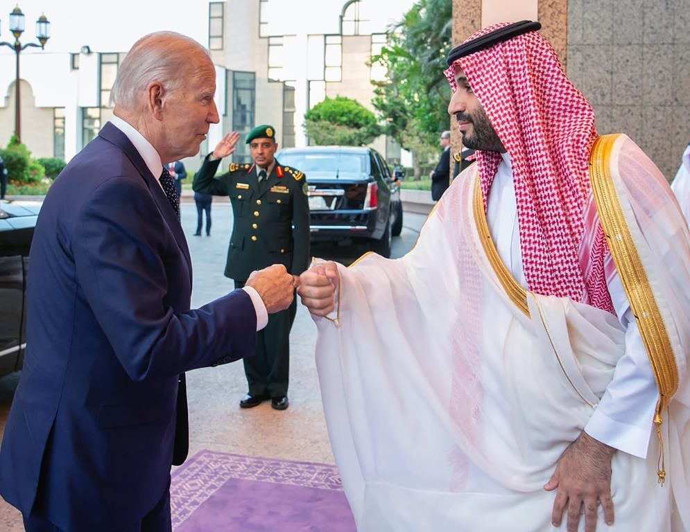 In this photo released by Saudi Press Agency (SPA), Saudi Crown Prince Mohammed bin Salman, right, greets President Joe Biden, with a fist bump after his arrival in Jeddah, Saudi Arabia, Friday, July 15, 2022. (Saudi Press Agency via AP)