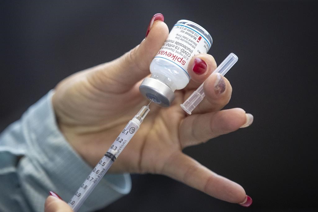 A vaccine dose is drawn out at a COVID-19 vaccine clinic in Kingston, Ont. on Sunday, January 2, 2022.