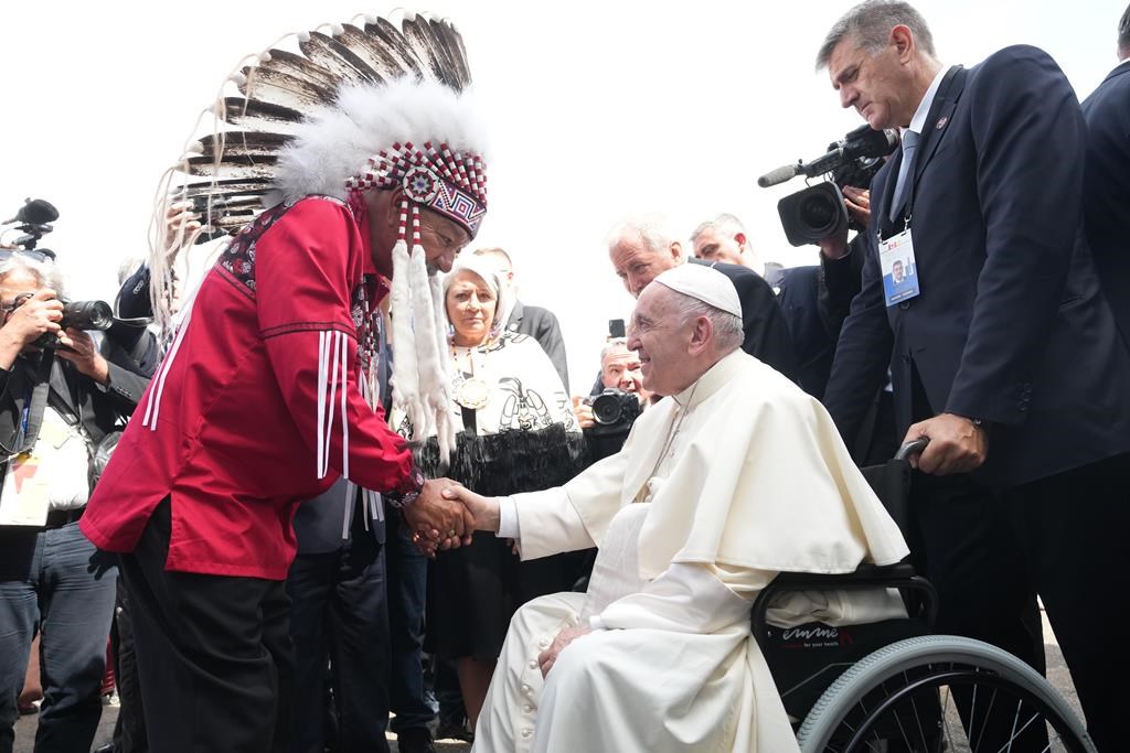 Pope Francis is greeted by George Arcand, Grand Chief of the Confederacy of Treaty Six First Nations, as he arrives in Edmonton on Sun., July 24, 2022.