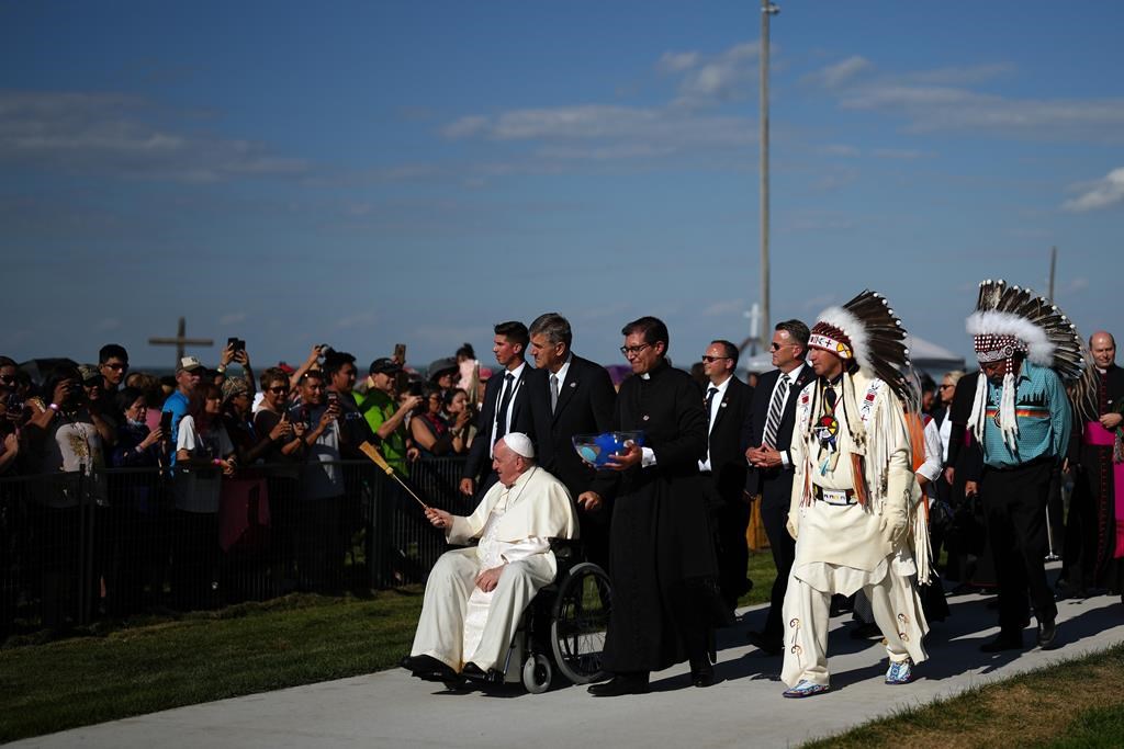 Pope Francis sprinkles holy water as he blesses the crowd during the annual pilgrimage event in Lac Ste. Anne, Alta. Tuesday, July 26, 2022. THE CANADIAN PRESS/Nathan Denette
