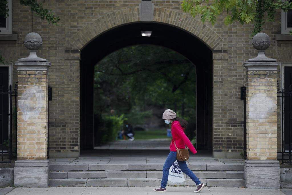 A woman walks on the University of Toronto campus in Toronto, Tuesday, Sept. 8, 2020. THE CANADIAN PRESS/Cole Burston.