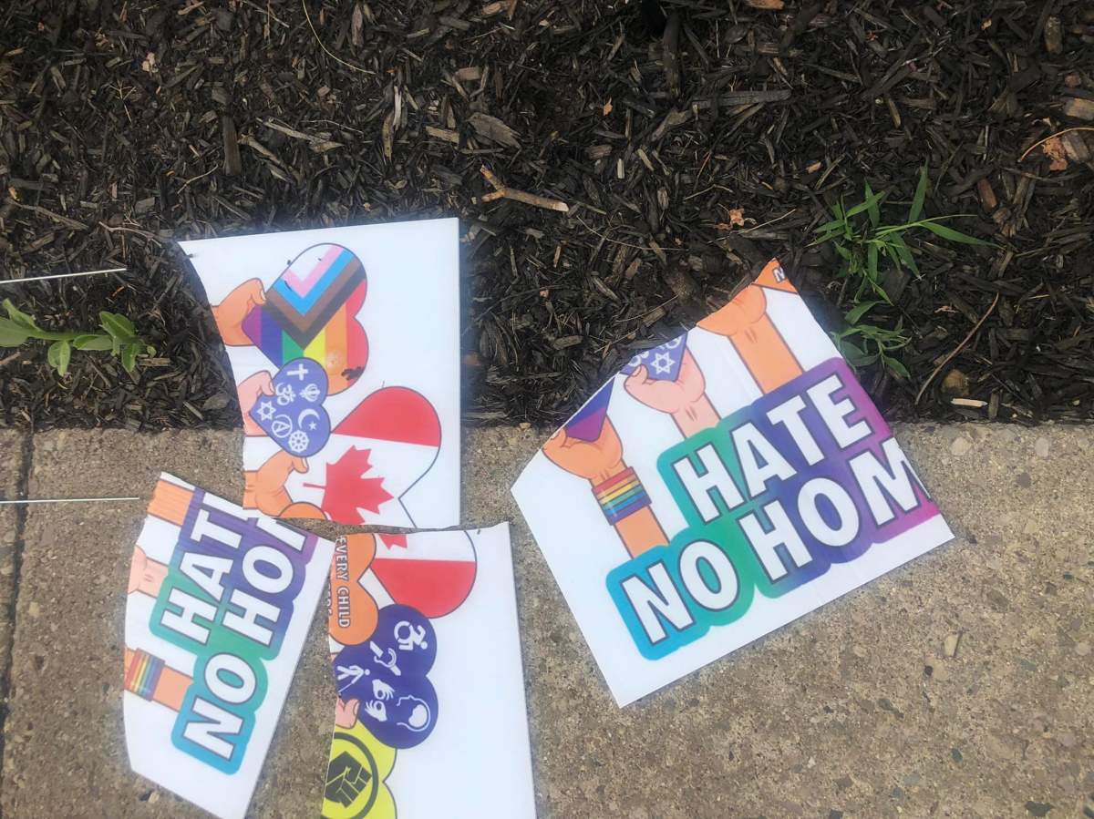 Signs destroyed outside the Indigo Lounge and Wellness Centre on June 27, 2022.