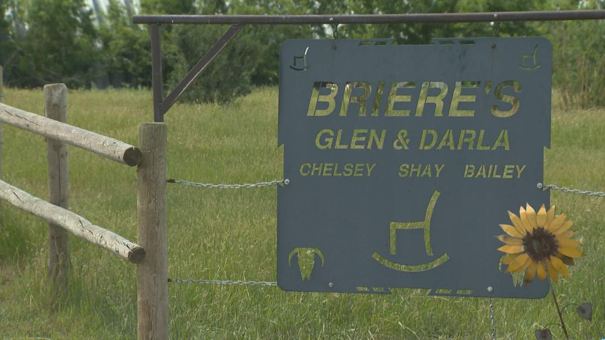 A family sign hangs outside at the entrance to the Briere home.