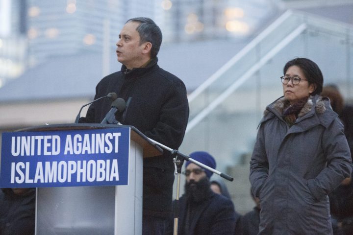 Toronto's Deputy Mayor Denzil Minnan-Wong, left, with Councillor Kristyn Wong-Tam, right, speaks at a vigil in response to shootings by an immigrant-hating, anti-Muslim, white supremacist at two mosques in Christchurch, New Zealand at Nathan Phillips Square in Toronto on Friday evening March 15, 2019.