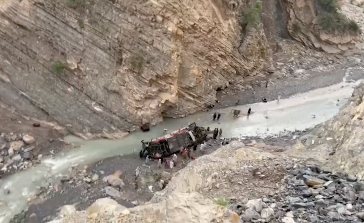 This frame grab from video shows rescue workers searching for survivors at the wreckage of a passenger bus that slid off mountain road and fell into a deep ravine in southwest Pakistan, Sunday, July 3, 2022.