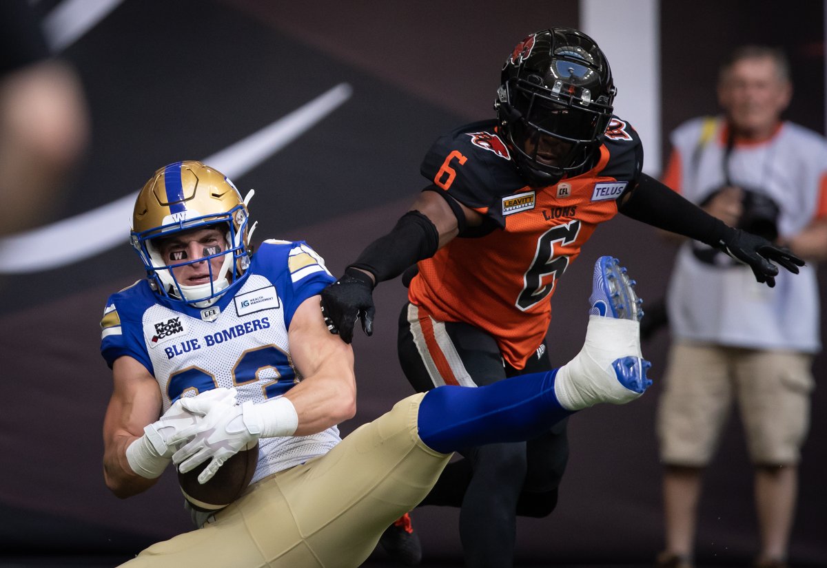 Winnipeg Blue Bombers' Dalton Schoen, left, makes a reception in the end zone to score a touchdown as B.C. Lions' T.J. Lee defends during the first half of CFL football game in Vancouver, on Saturday, July 9, 2022.