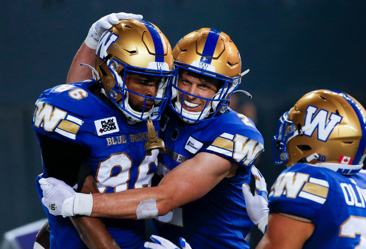 Winnipeg Blue Bombers' Carlton Agudosi (86) and Greg Ellingson (2) celebrate Agudosi’s game winning touchdown against the Calgary Stampeders during the second half of CFL action in Winnipeg, Friday, July 15, 2022. 