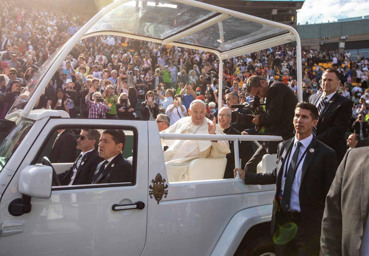 People gather to get a close look as Pope Francis arrives for mass in Edmonton, during his Papal visit across Canada on Tuesday July 26, 2022. Pope Francis apologized to the Indigenous communities for the Roman Catholic Church's role in the residential school system.