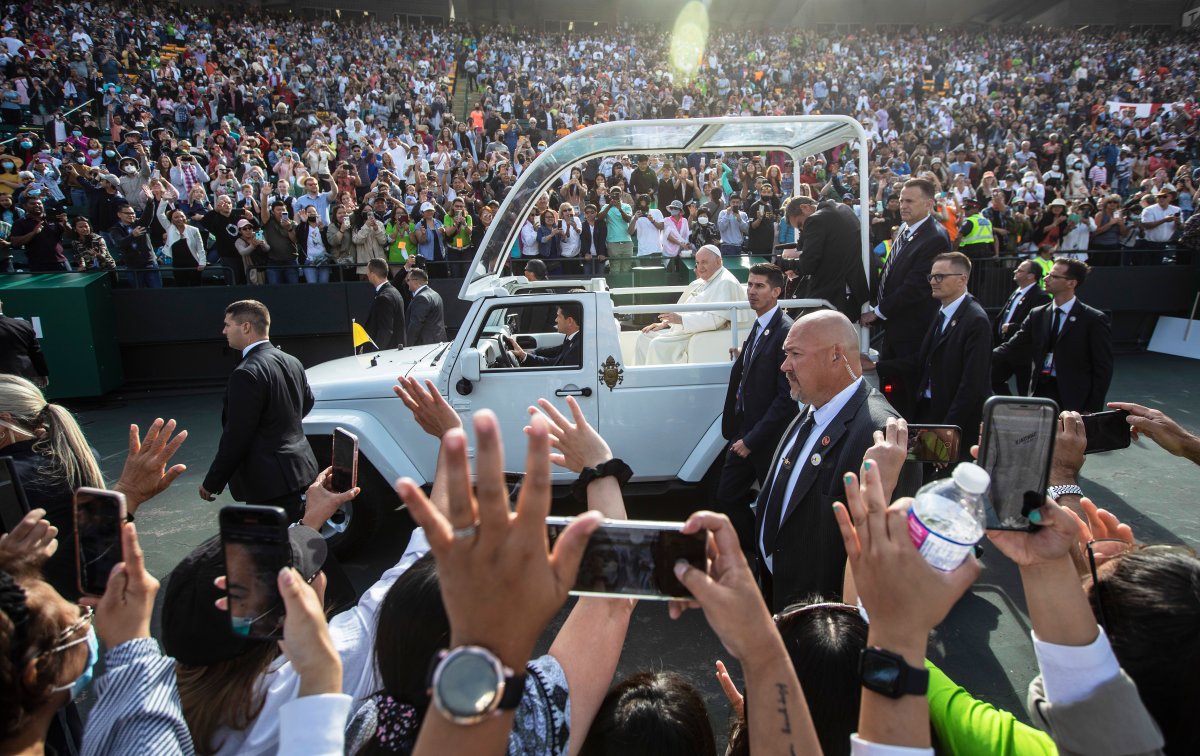 People gather to get a close look as Pope Francis arrives for mass in Edmonton, during his Papal visit across Canada on Tuesday July 26, 2022. Pope Francis apologized to the Indigenous communities for the Roman Catholic Church's role in the residential school system.