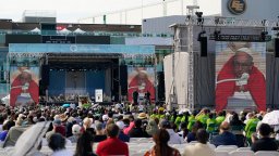 People listen as Pope Francis delivers an open air Mass at Commonwealth Stadium, Tuesday, July 26, 2022, in Edmonton, Alberta. Pope Francis traveled to Canada to apologize to Indigenous peoples for the abuses committed by Catholic missionaries in the country's notorious residential schools.