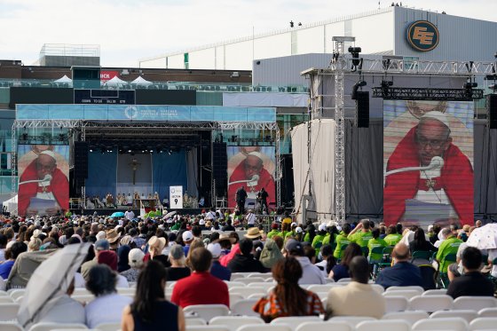 People listen as Pope Francis delivers an open air Mass at Commonwealth Stadium, Tuesday, July 26, 2022, in Edmonton, Alberta. Pope Francis traveled to Canada to apologize to Indigenous peoples for the abuses committed by Catholic missionaries in the country's notorious residential schools.