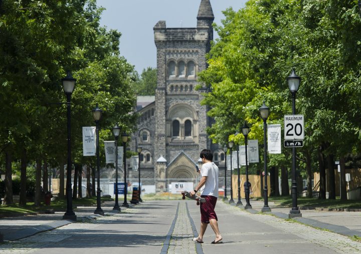 A person walks past the University of Toronto campus during the COVID-19 pandemic in Toronto on Wednesday, June 10, 2020. 