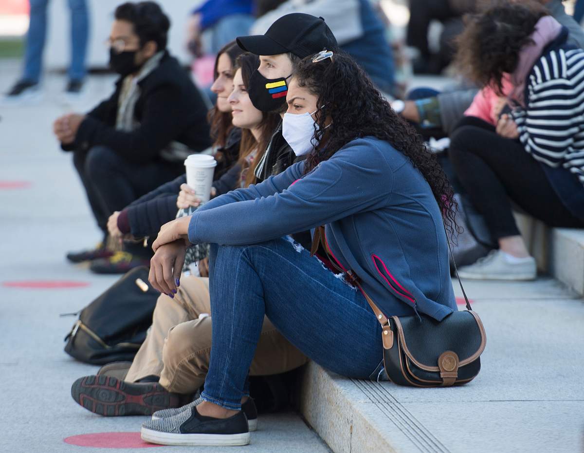 People wear face masks as they attend an outdoor event in Montreal.