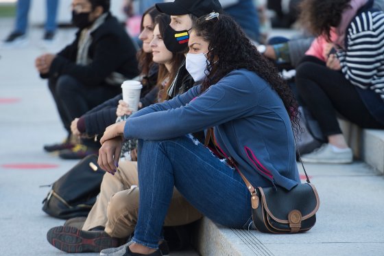 People wear face masks as they attend an outdoor event in Montreal.