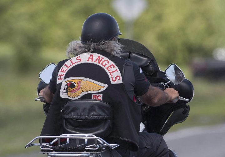 A member of the Hells Angels arrives for a national gathering in Saint-Charles-sur-Richelieu, Que., Friday, August 10, 2018.
