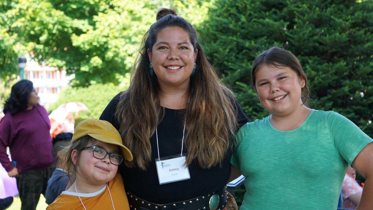 Rubiina Keays (left), her mother Ashley Keays and her little sister Luna Keays, watch Pope Francis deliver a mass from outside the National Shrine of Sainte-Anne-de-Beaupré on Thurs. July 28, 2022.