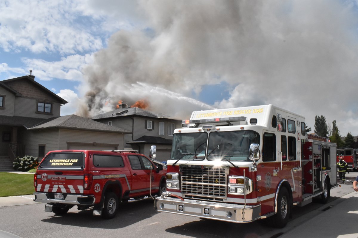 Crews battle a house fire in the west Lethbridge neighbourhood of Riverstone on Tuesday, July 26, 2022. 