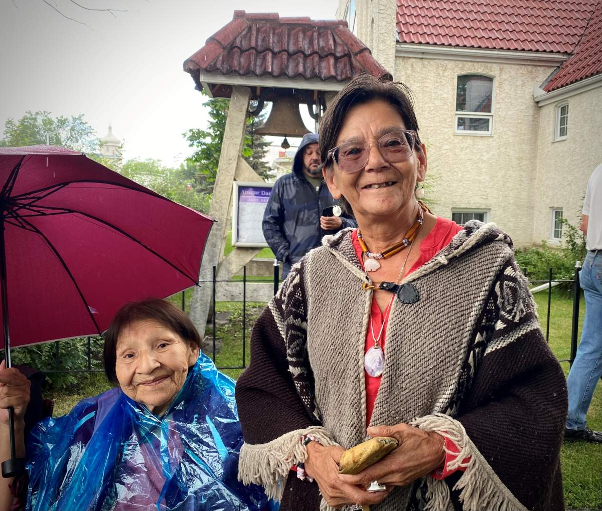 Debby Gunville waits outside the Sacred Heart Church of the First Peoples in Edmonton on Mon. July 25, 2022, for a glimpse of Pope Francis as he tours Canada on his reconciliation pilgrimage.
