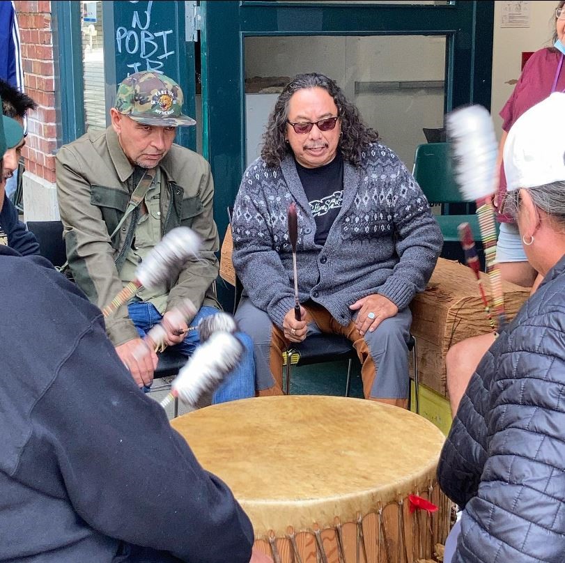 Perry Omeasoo sits in a drumming circle