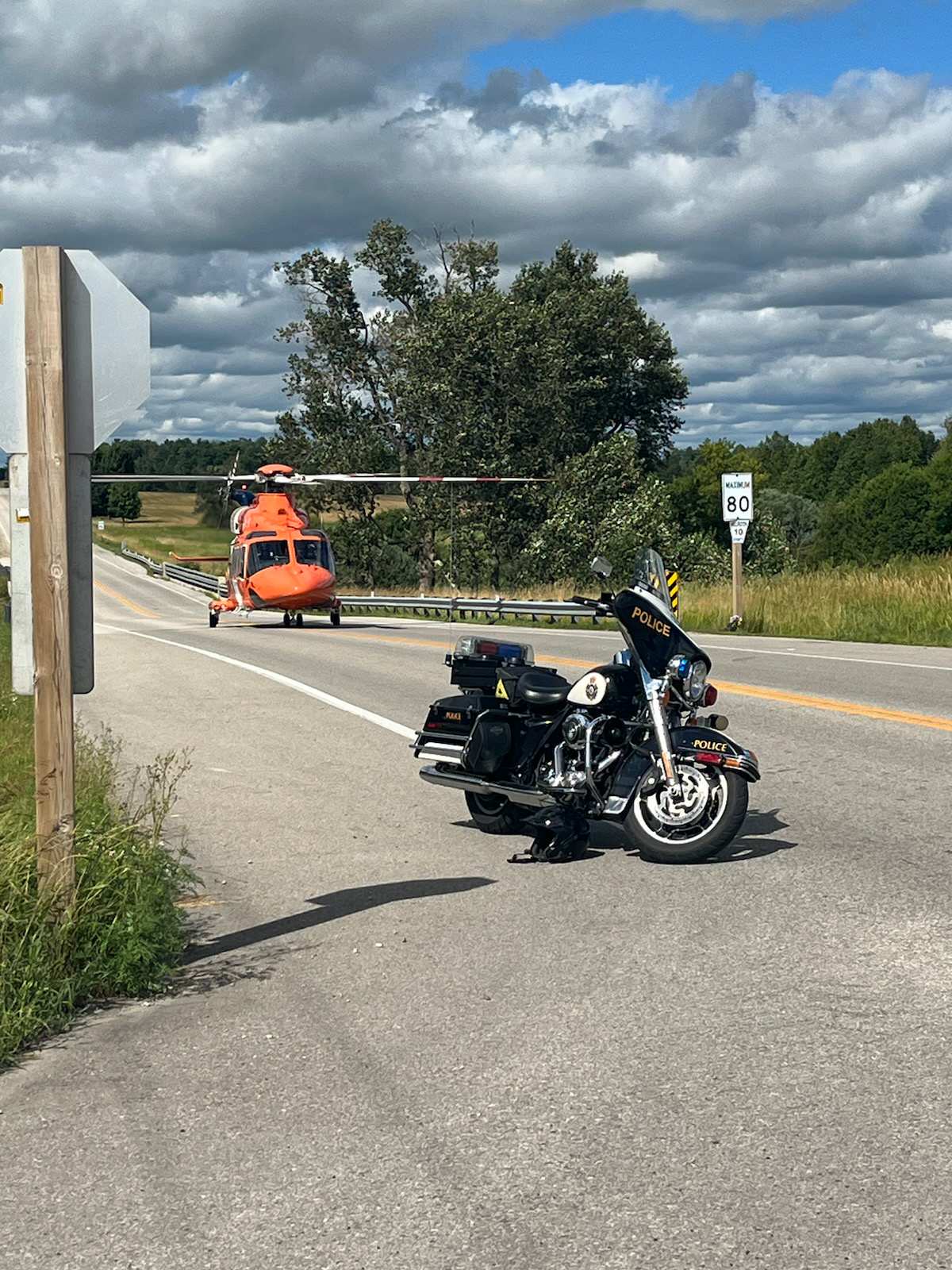 Air ambulance and OPP motorcycle at scene of crash in Mapleton.