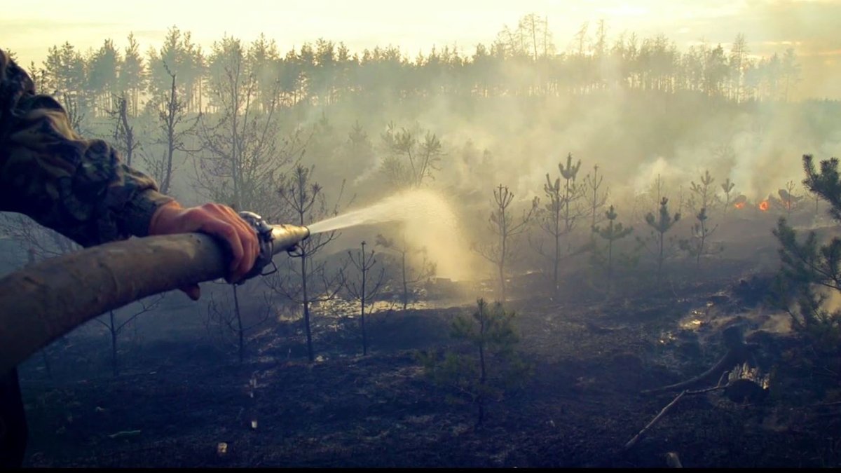 A firefighter douses hotspots on a wildfire. The Kelowna Fire Department says the recent warm weather has created dry conditions across the region.