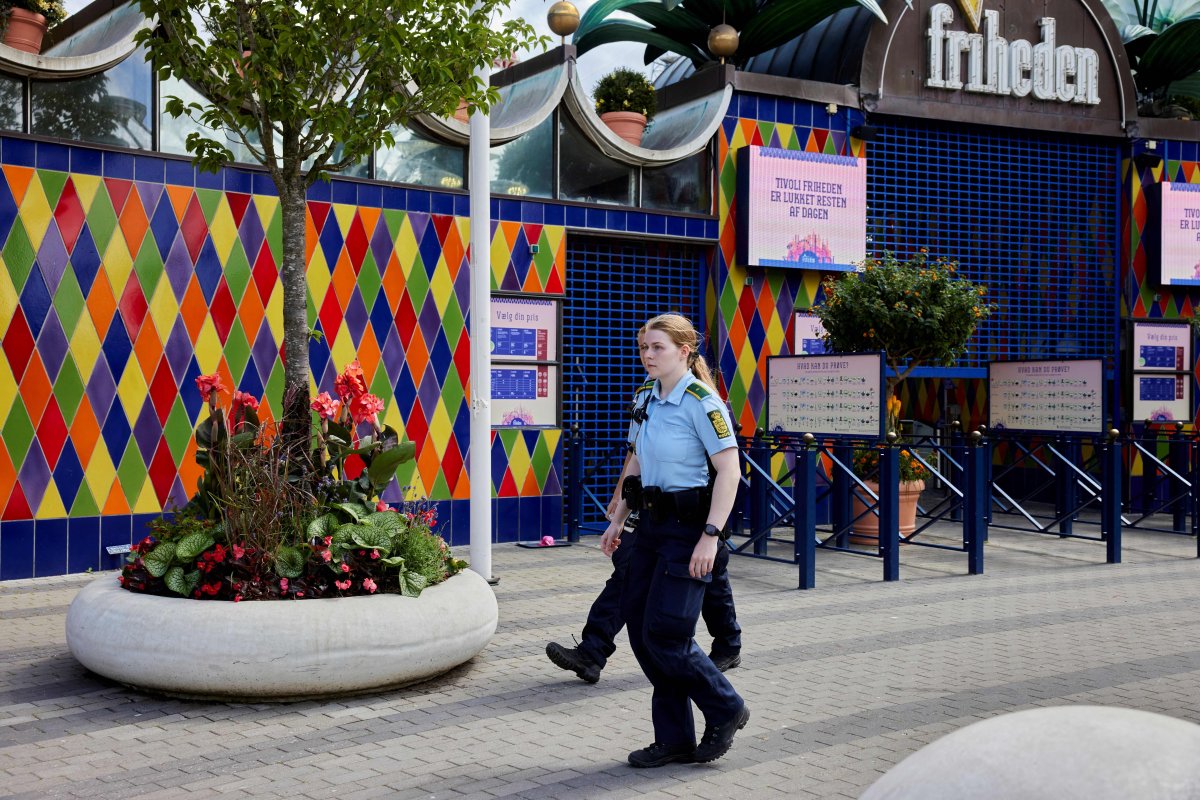 Police walk outside the closed Tivoli Friheden amusement park, in Aarhus, western Denmark, after a 14-year-old girl was killed and a 13-year-old boy injured in a roller coaster accident, on July 14, 2022.