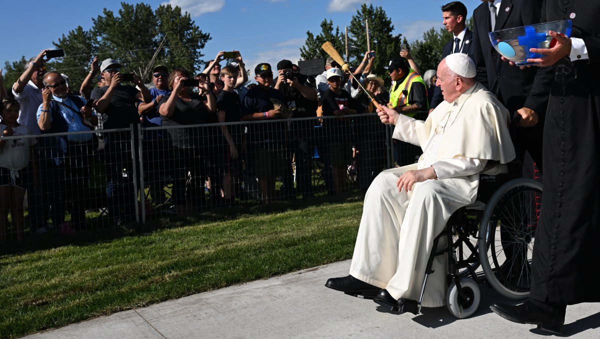 Pope Francis blesses pilgrims with water from the lake during the Lac Ste. Anne Pilgrimage and Liturgy of the Word at Lac Ste. Anne, northwest of Edmonton, Alberta, Canada, July 26, 2022.