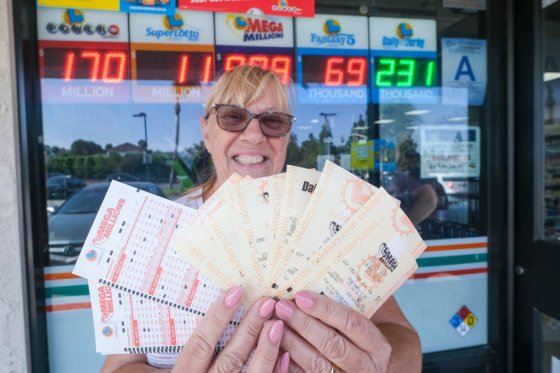 Liz Evans shows off her Mega Millions lottery tickets at a 7-Eleven convenience store in Chino Hills, California, July 28, 2022.