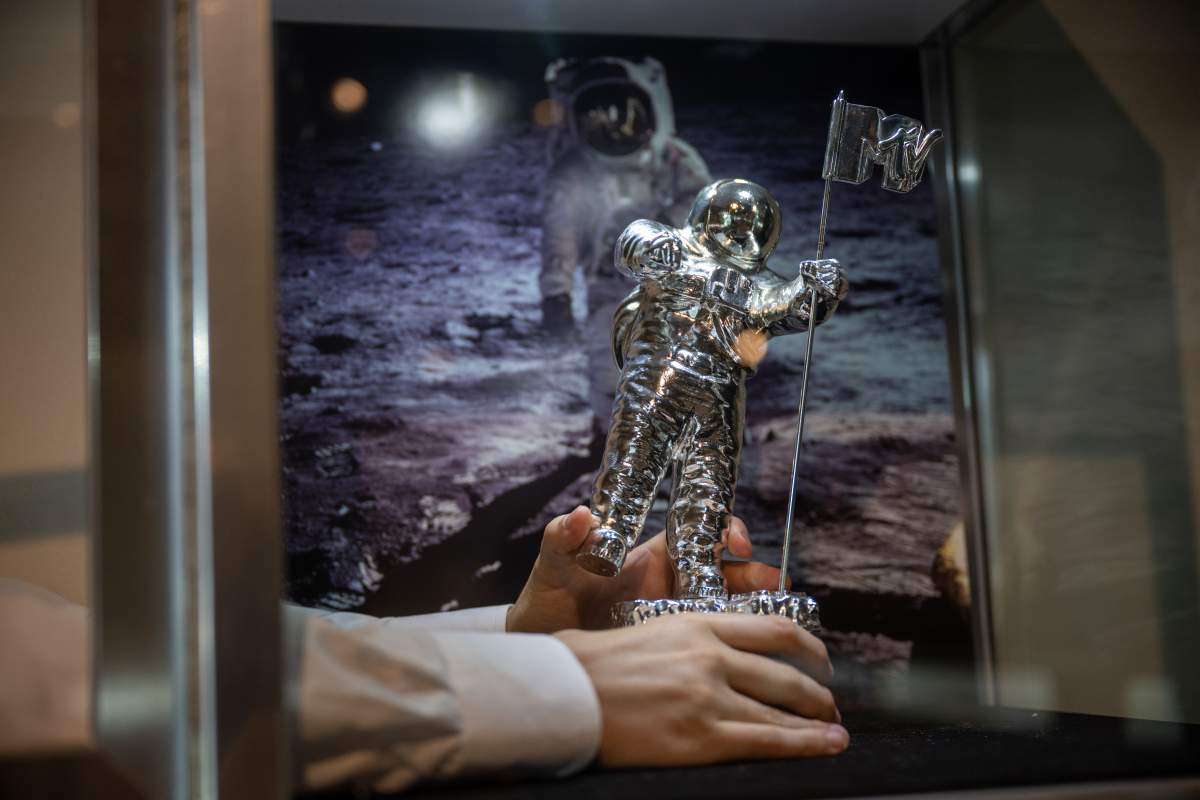 An art handler holds The “Original Moonman” MTV VMA Statuette Presented to Aldrin in 1984 during a press preview at Sotheby's on July 21, 2022 in New York City. The statuette used for the MTV awards was chosen from a picture of Aldrin planting the United States Flag on the Moon as the symbol for newest award show, the MTV VMA's.