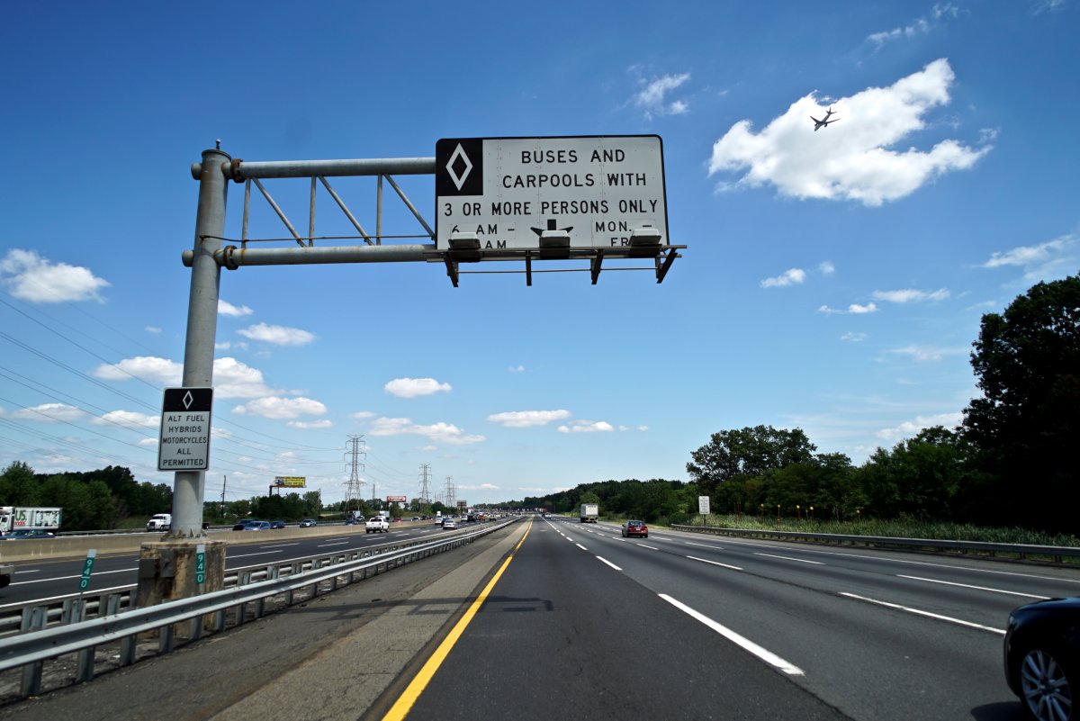 A carpool lane sign on a highway