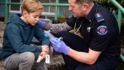 Ian Tait, an advanced care paramedic in B.C. helps a boy having breathing trouble.