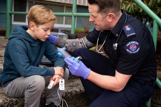 Ian Tait, an advanced care paramedic in B.C. helps a boy having breathing trouble.