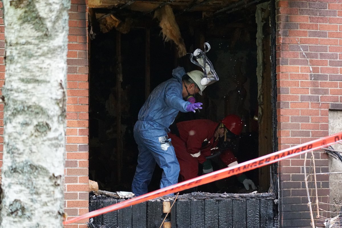 Fire investigators on the scene of an apartment building fire in Dartmouth on July 3, 2022. 